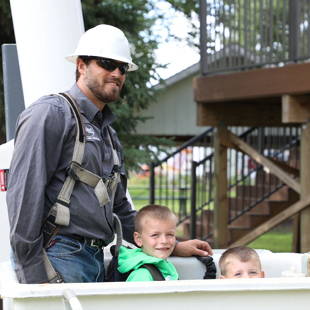 Lineman with Children in Bucket Truck