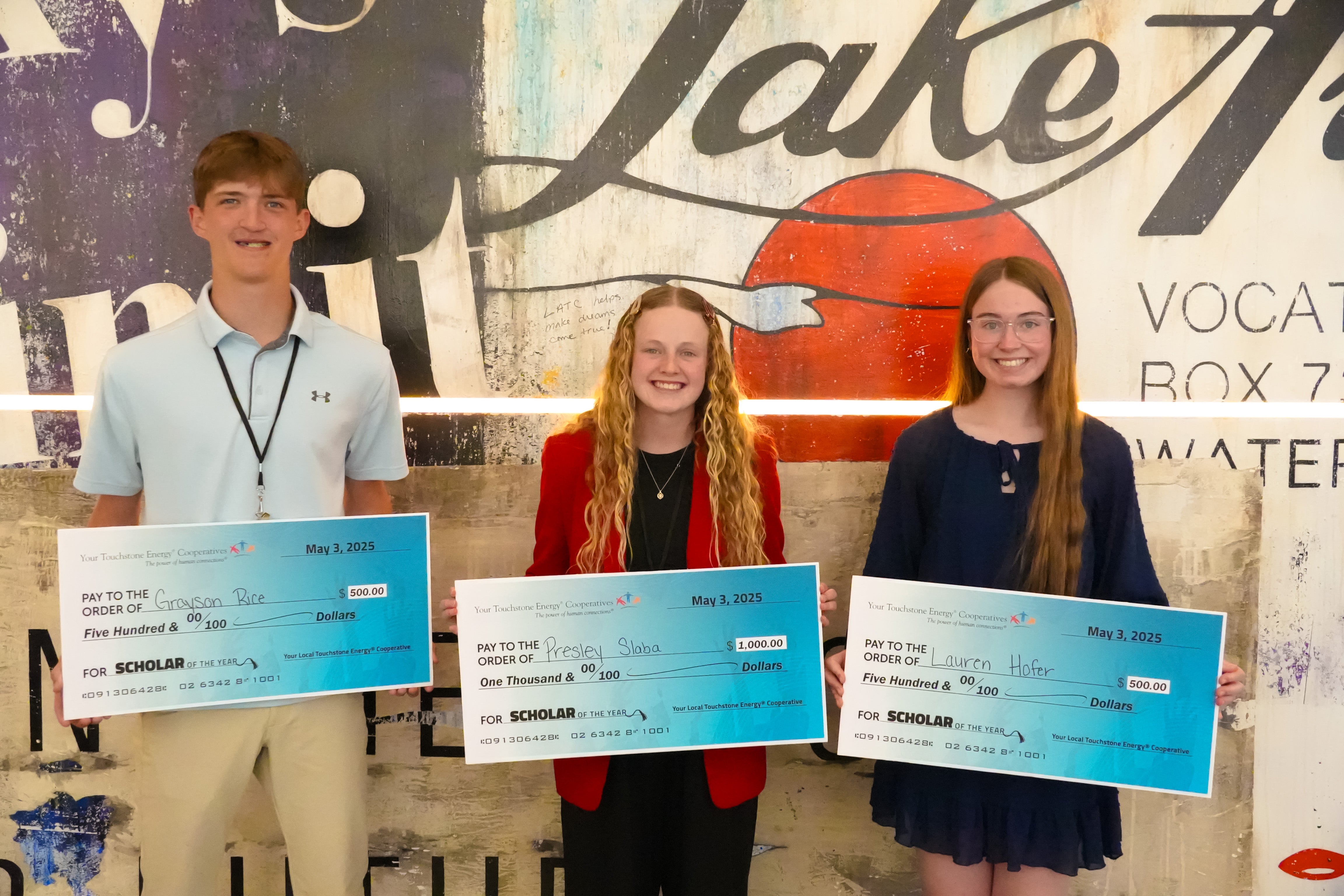 Scholars holding big checks