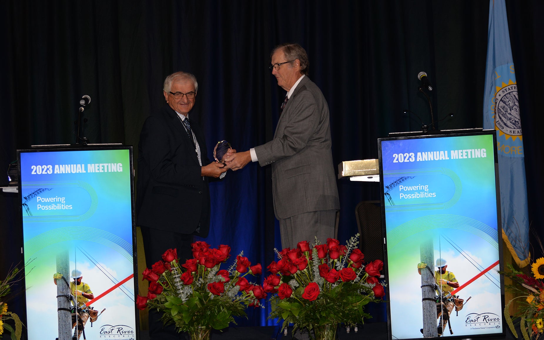 Ervin Fink is presented with an award from president Jim Ryken