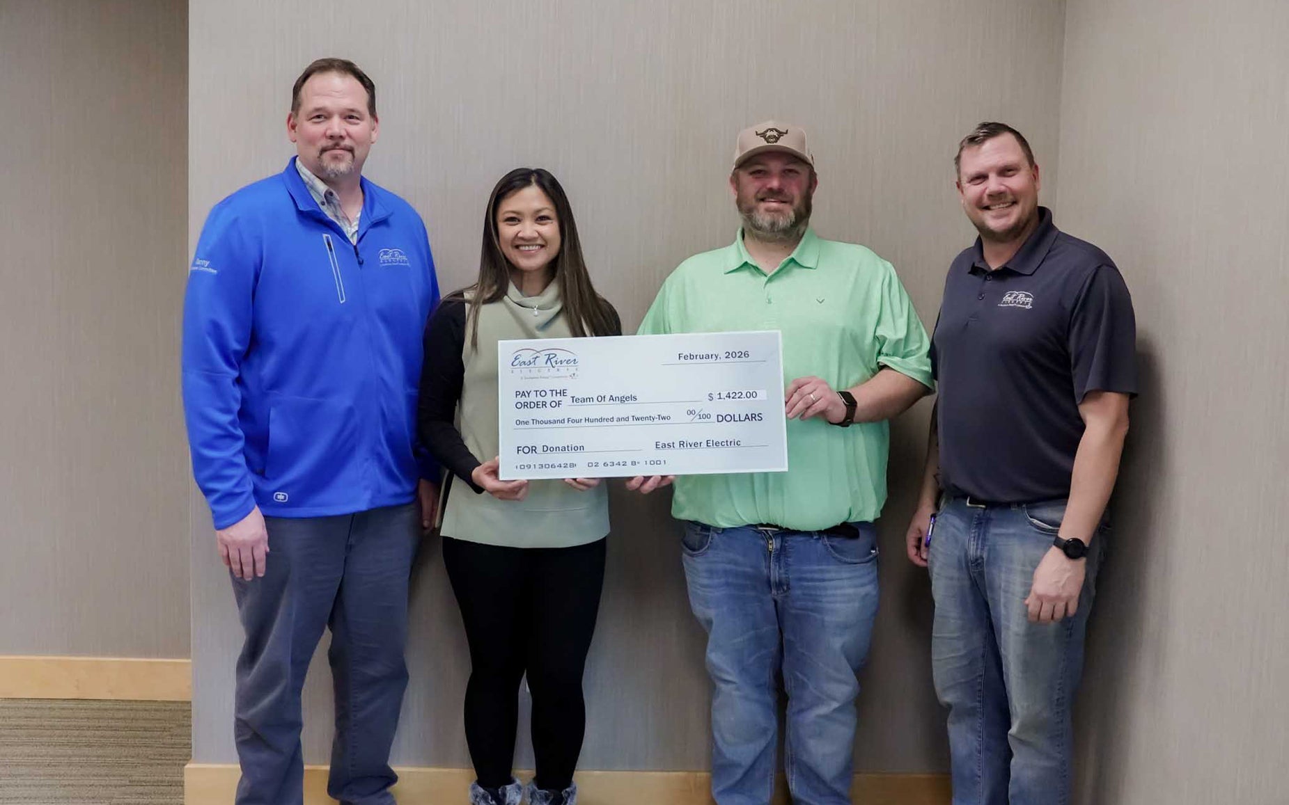 Team of Angels is presented with check from East River Electric